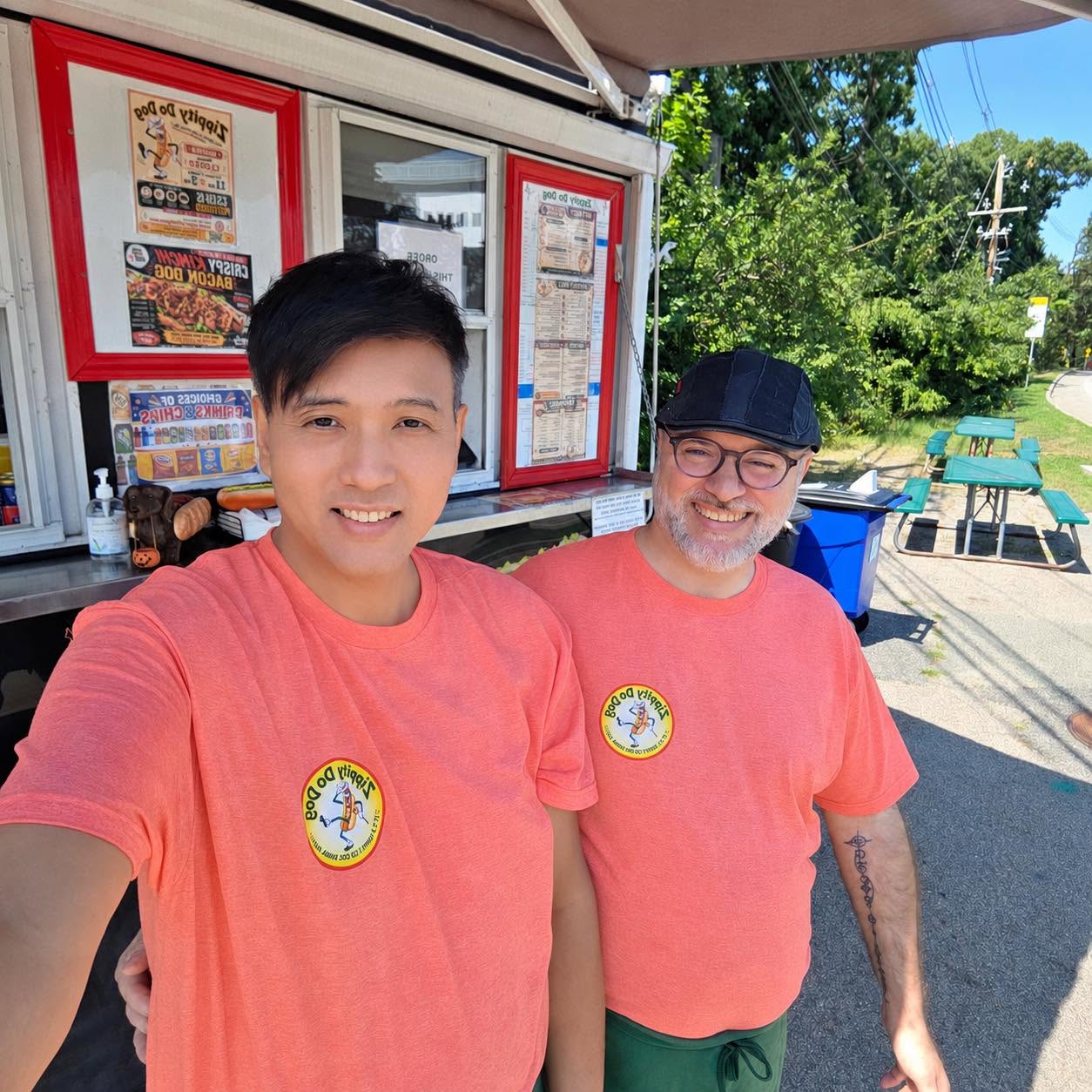Chef Alan and Chef Paponake MacIntosh in Zippity Do Dog shirts in front of the food trailer