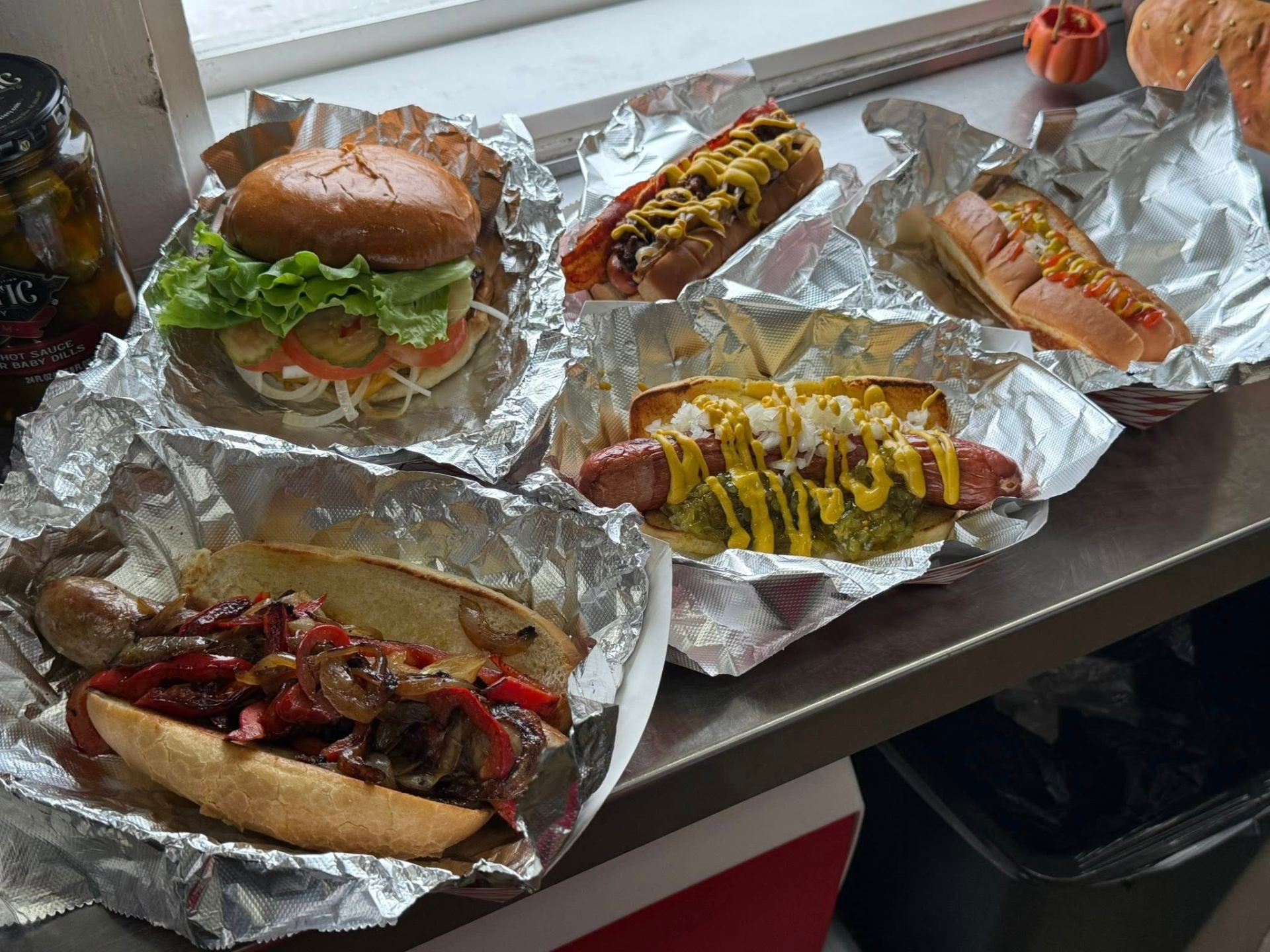 Italian Pig Rock sausage hoagie with peppers and onions alongside specialty dogs and a burger